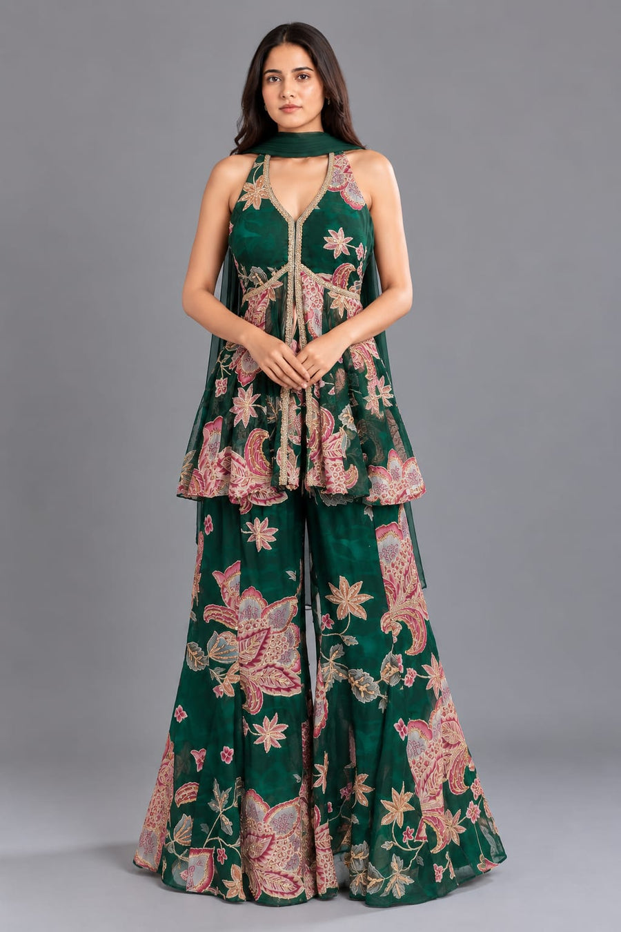 Elegant floral peplum sharara set with intricate embroidery, flared bottoms and a matching choker dupatta, designed for wedding, sangeet and festive events.