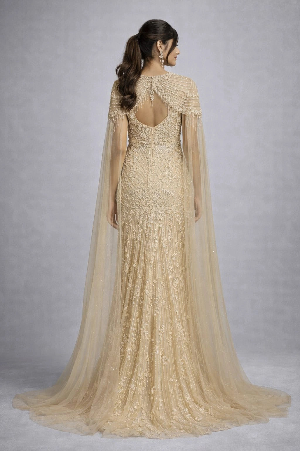  beige embroidered gown with a cape