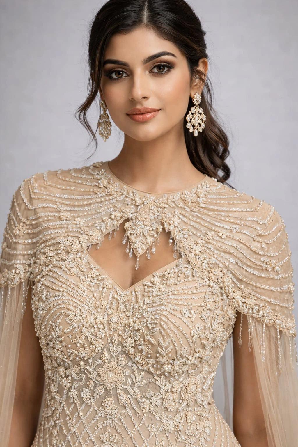  beige embroidered gown with a cape