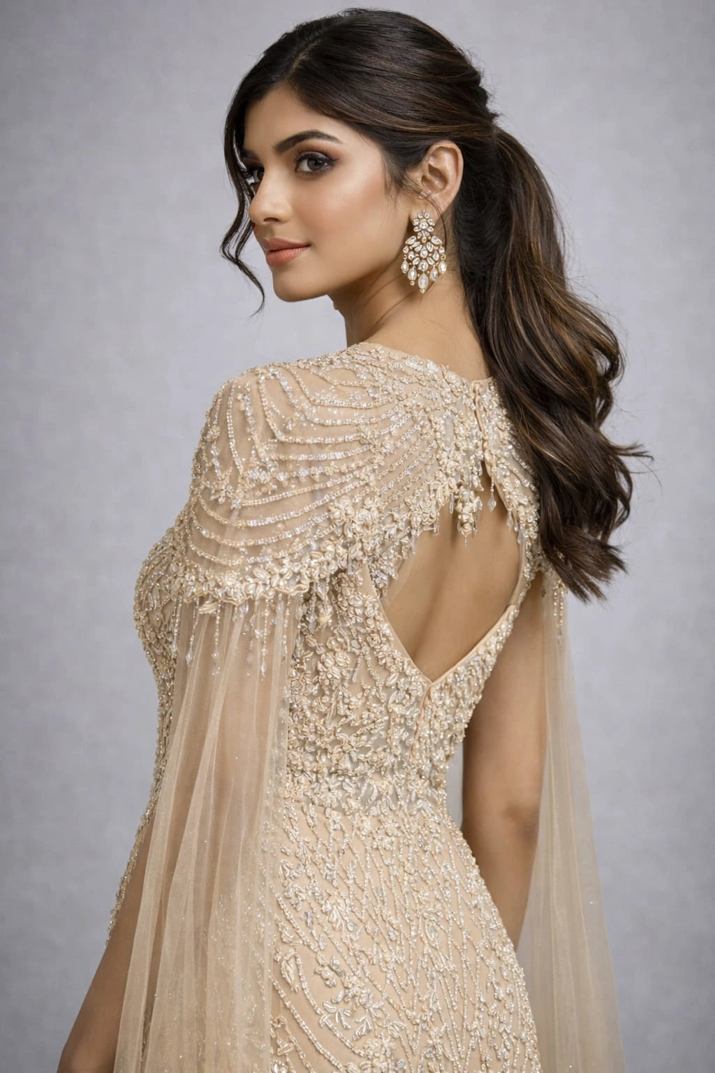  beige embroidered gown with a cape