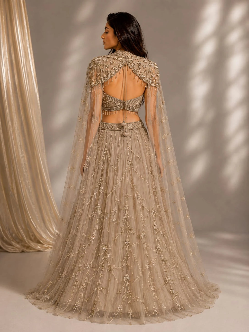 gold embellished cape gown